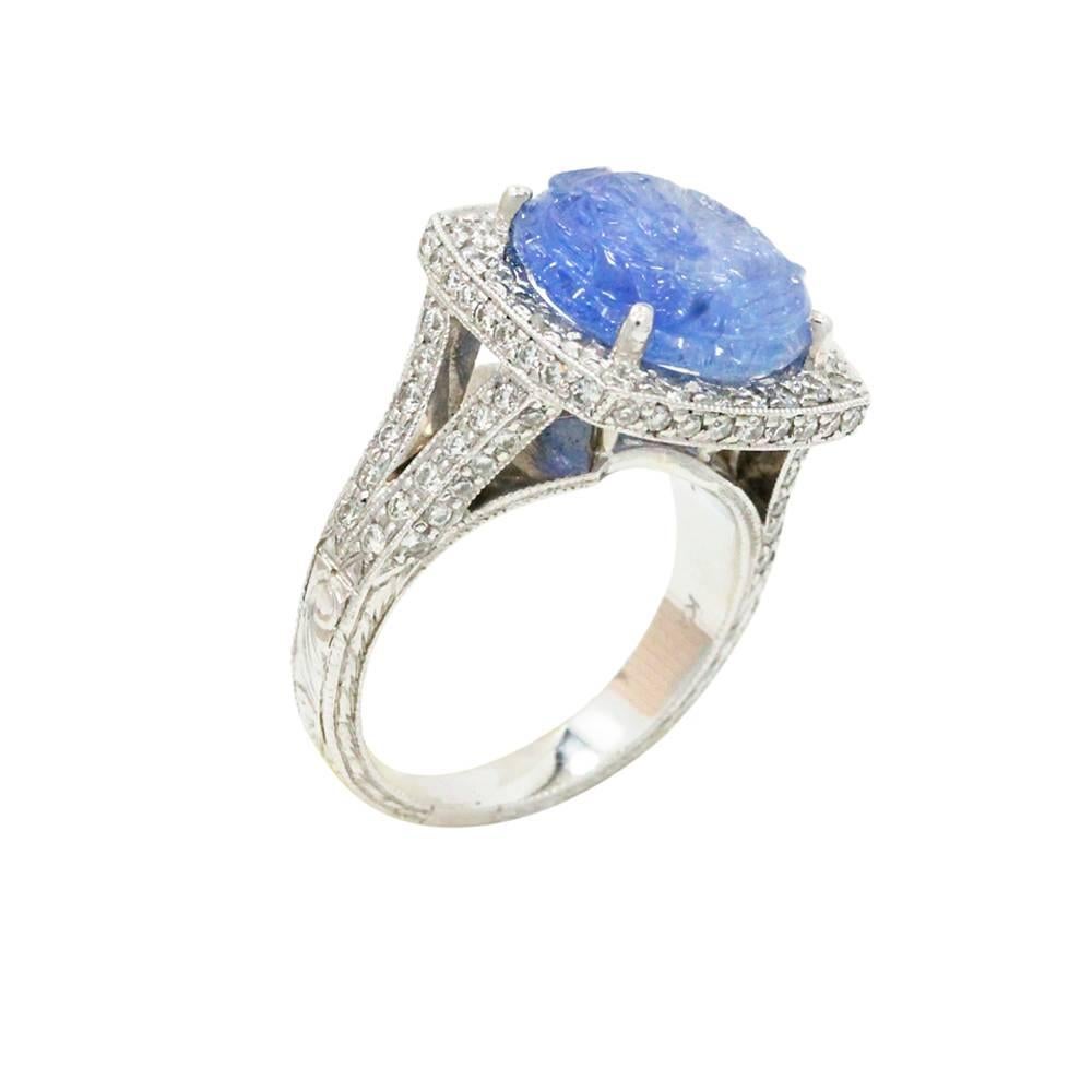 Platinum Ring With Center Carved Sapphire Stone Weighing A Total Carat Weight Of 7.58ct And Surrounding Diamonds Weighing A Total Carat Weight Of 1.07ct. This Ring Is A Size 6.