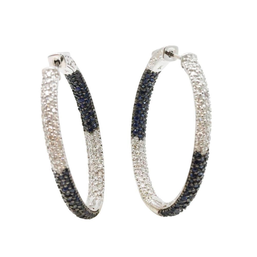 14K White Gold Hoop Earrings With 148 Blue Sapphires Weighing A Total Carat Weight Of 1.88ct And 146 Diamonds Weighing A Total Carat Weight Of 1.44ct. These Earrings Are 1.5 Inches In Length.