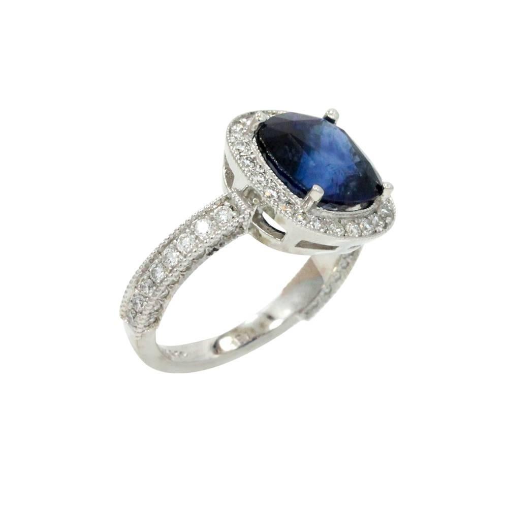 18K White Gold Ring With Center Sapphire Stone Weighing A Total Carat Weight Of 5.54ct And Surrounding Diamonds Weighing A Total Carat Weight Of 2.19ct. This Ring Is A Size 6.