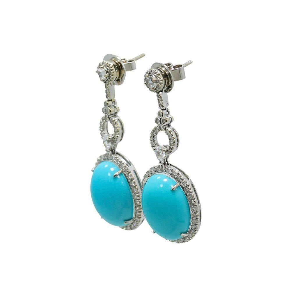 We have these beautiful 18k white gold diamond and turquoise earrings. The diamonds weigh 1.98 carats total weight and the oval turquoise weighs 21.23 carats total weight. They meaure 1.875" in length and weigh a total of 15.4 grams. These