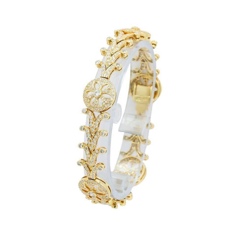 We have this beautiful 18k yellow gold and diamond fashion bracelet. The diamonds weigh 5.70 carats total weight. It measures 7.00" in length and weighs a total of 22.8 grams. The bracelet is in excellent condition. Please see all pictures and