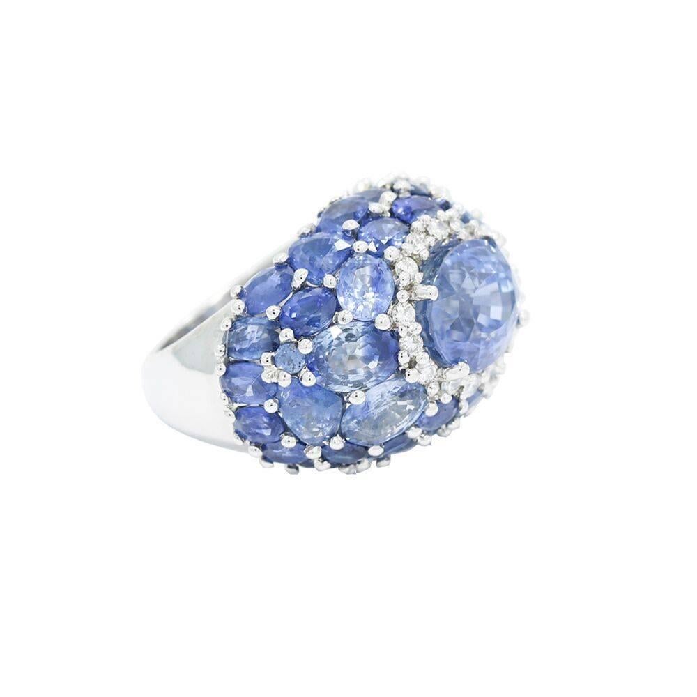 Up for sale is this 18k white gold oval sapphire and diamond dome ring. The center sapphire weighs approximately 5.50 carats total weight, 40 sapphires weighing approximately 10. carats total weight and 14 diamonds weighing .28 carats total weight.
