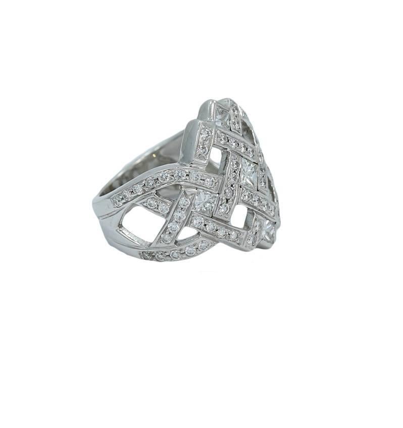 We have this 18k white gold round and princess cut diamond ring. It has seventy (75) diamonds weighing approximately 2.0 carats total weight. It measures .075" in height and weighs a total weight of 9.1 grams. The ring sits at a size 5 and can