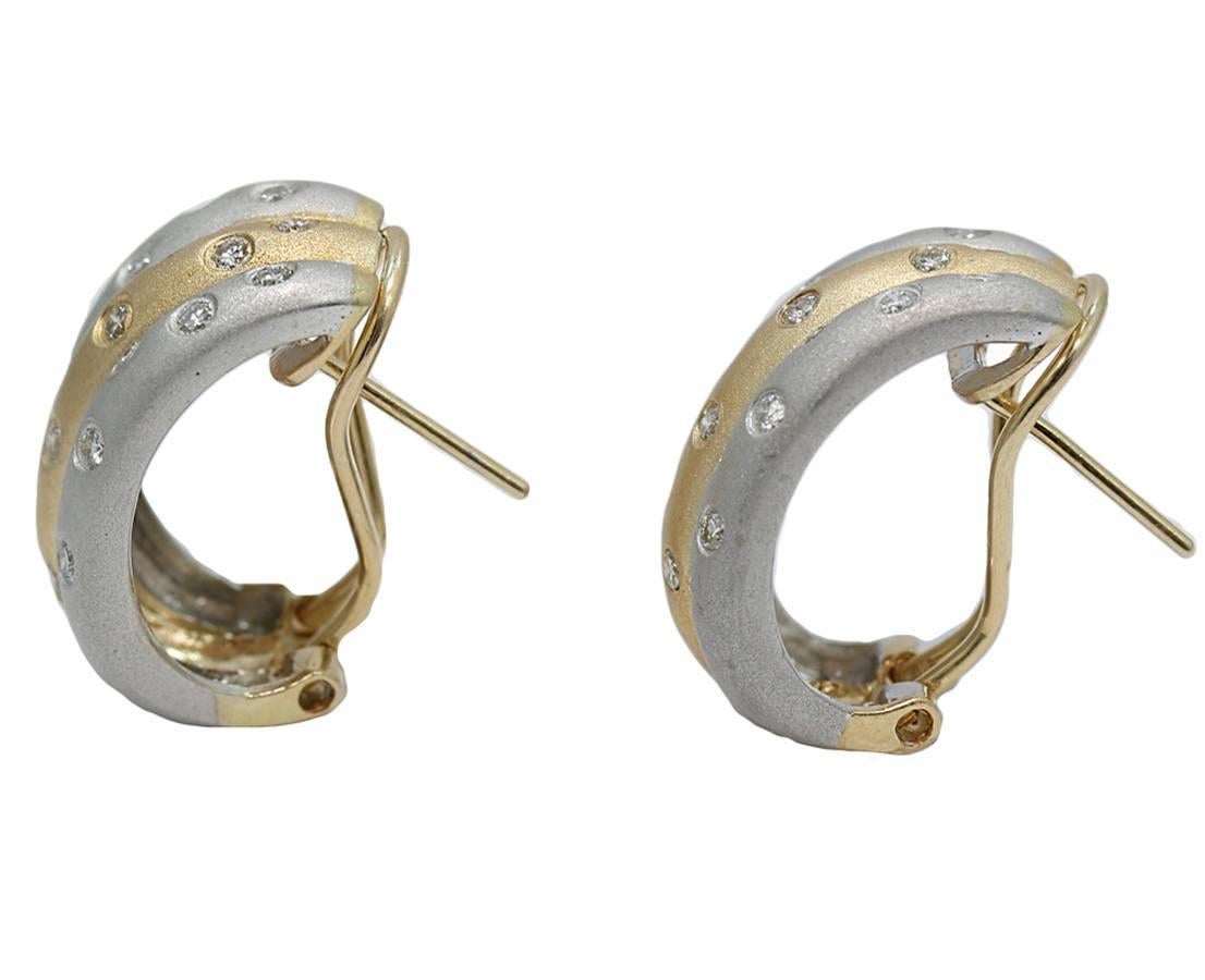 We have these 14k two tone brushed finish diamond earrings. They have 44 burnished set diamonds weighing approximately 0.88 carats total weight. They measure 0.75" in height and weigh a total weight of 9.8 grams. They are stamped with 14K and