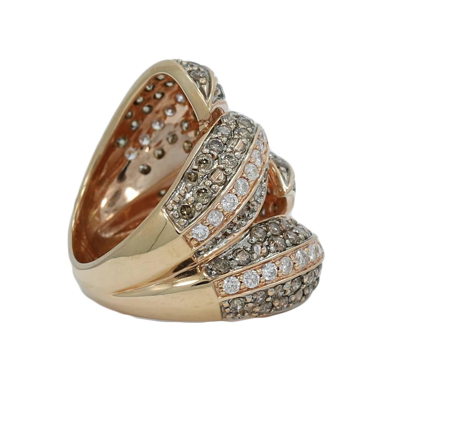 We have this 18k rose gold and brown diamond fashion ring. It has one hundred twenty 120 diamonds weighing approximately 2.50 carats total weight. The ring sits at a size 5 and can be adjusted. It weighs a total of 9.6 grams and is in great