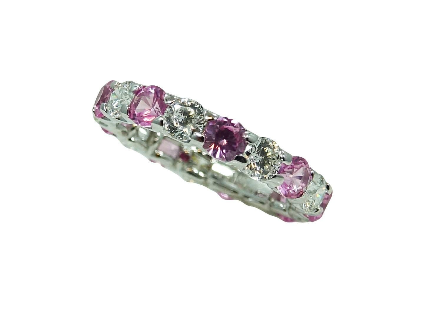 18K White Gold Estate Roberto Coin Cento Eternity Band With 9 Diamonds With A Total Carat Weight Of 1.45ct G Color And VS2 Clarity and 9 Pink Sapphires Weighing A Total Carat Weight Of 1.88ct. This Ring Is A Size 5.