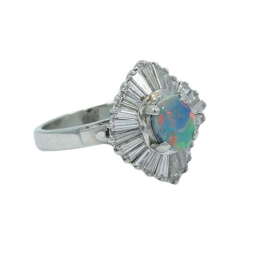 Platinum Ring with Black Opal Center and  twenty four (24) side baguette diamonds weighing approximately 1.64 carats total weight. The ring is a size 6.75 and can be easily adjusted. It weighs a total of 10.4grams. 