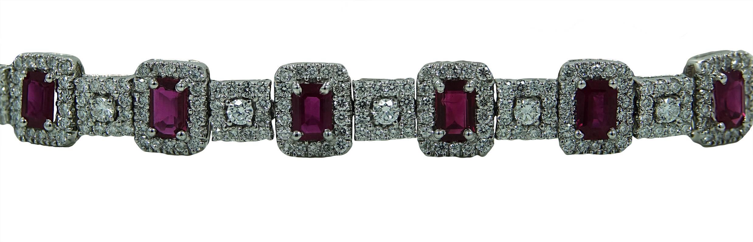 18K White Gold Bracelet With 13 Emerald Cut Rubies Weighing A Total Carat Weight Of 7.50 and Surrounding Diamonds Weighing A Total Carat Weight Of 5.63ct. This Bracelet Hooks Together Using A Box Clasp and Is 8 Inches In Length.