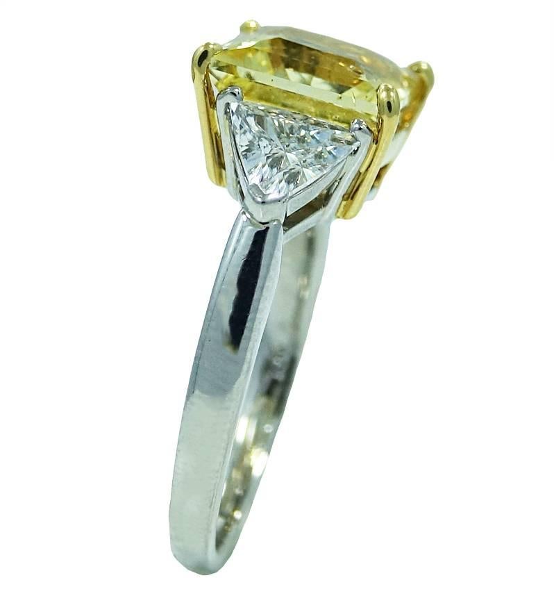 18K White Gold RIng With Center Princess Cut Yellow Sapphire Weighing A Total Carat Weight Of 5.16ct and 2 Trillion Diamonds Weighing A Total Carat Weight Of 1.00ct G-H Color and VS2 Clarity. This Ring Is A Size 6 and is Sizeable.
