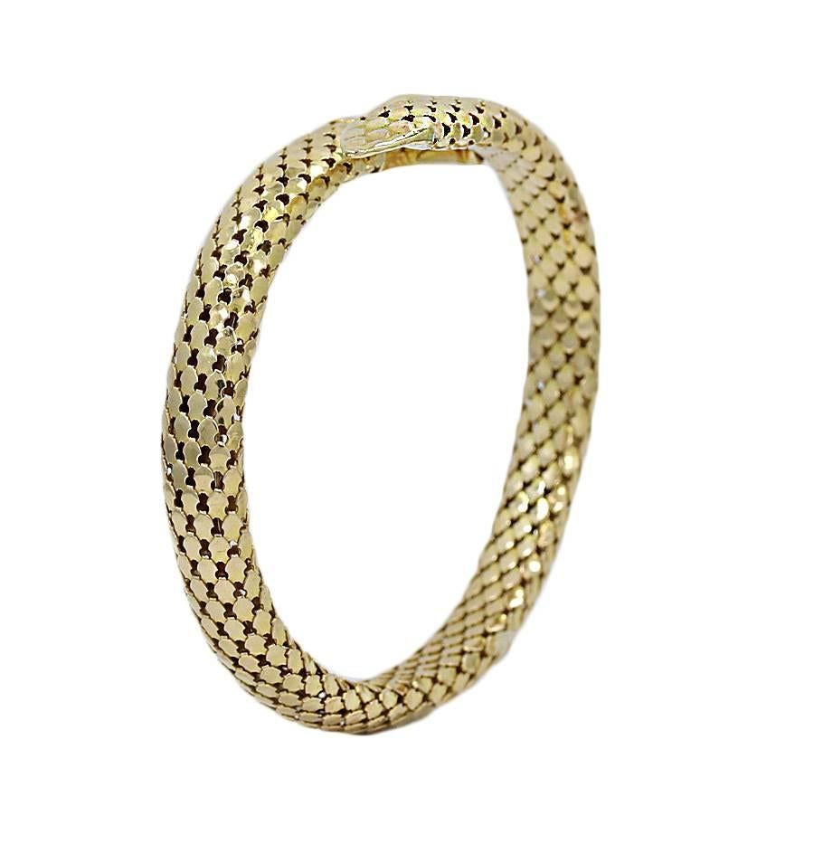 Yellow Gold Serpent Coil Bracelet with Ruby Eyes In Excellent Condition For Sale In Naples, FL