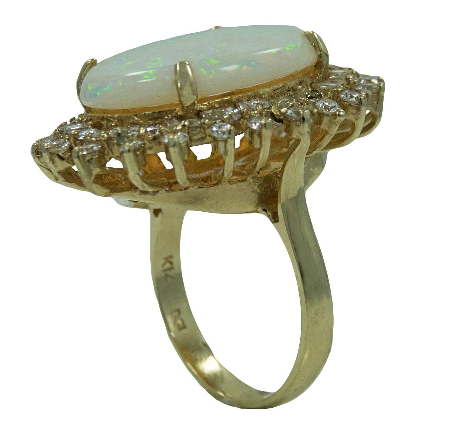 14K Yellow Gold Ring With Center Opal Stone Weighing A Total Carat Weight Of 8.95ct and Diamonds With a Total Carat Weight Of 1.72ct. This Ring Is A Size 6 and is in Beautiful Condition.