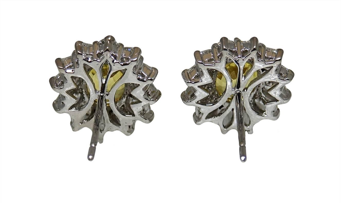 18K White Gold Earrings With 2 Yellow Sapphires Weighing A Total Carat Weight Of 6.75ct and 24 Surrounding Diamonds Weighing A Total Carat Weight Of 3.74ct H-I Color and VS1-VS2 Clarity.