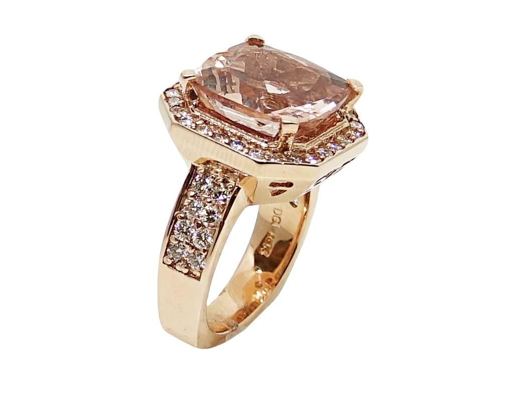 14K Rose Gold Ring With Center Morganite Stone Weighing A Total Carat Weight Of 8.71ct and Outlining Diamonds Weighing A Total Carat Weight Of 1.09ct H Color and VS Clarity. This Ring Is A Size 6.