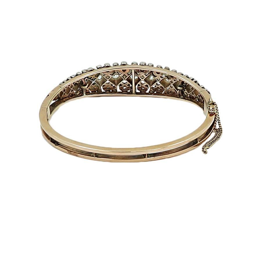 14K Rose Gold bangle bracelet with rose cut diamonds. The bracelet has 64 diamonds that weigh approximately 2.50 carats total weight. It measures 2.5 inches in diameter and weighs a total of 21.6 grams. It is in excellent condition. 