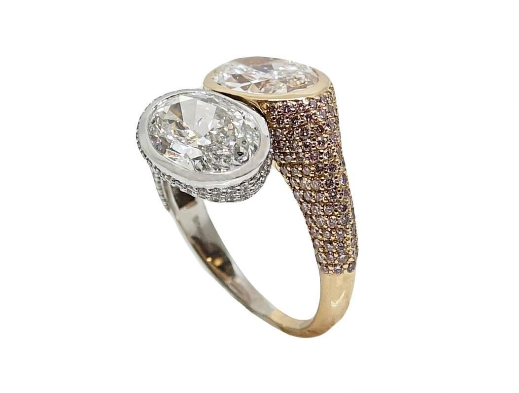 This Stunning Ring is Two Toned With 18K Pink Gold and Platinum Ring With 2 Oval Cut Diamonds Weighing A Total Carat Weight Of 6.22 Carats. The First Diamond is 3.18 Carats F Color and SI2 Clarity, The Second is 3.04 Carats E Color and SI2 Clarity.