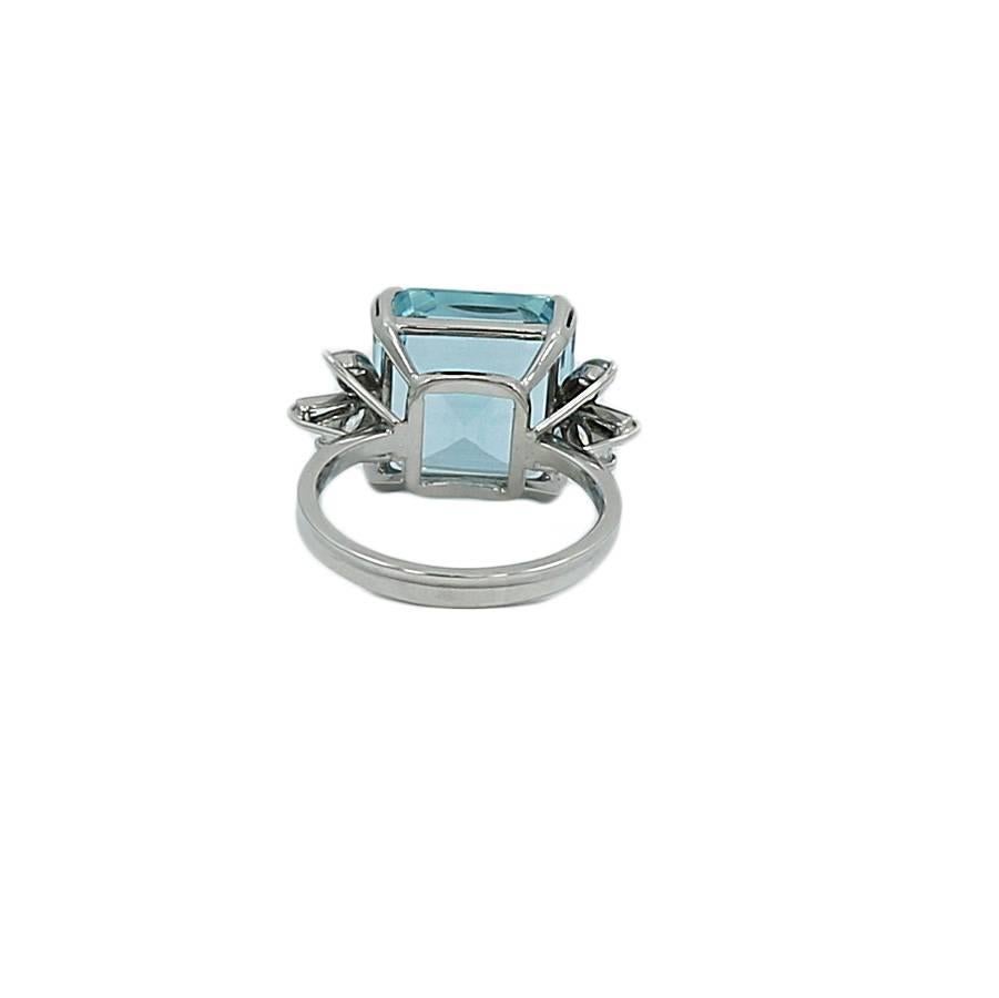 18k white gold ring with aquamarine and diamond. The aquamarine weighs approximately 7.00 carats total weight, the 4 marquise diamonds weigh approximately .20 carats total weight and the 2 baguette diamonds weigh approximately .02 carats total