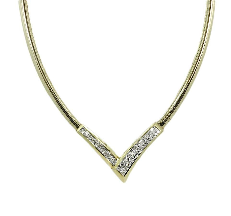 14k yellow gold omega V shape princess cut invisible set diamond necklace. It has 83 diamonds H-I/SI that weigh approximately 5.78 carats total weight. The omega weighs 52.8 grams and is in excellent condition.
