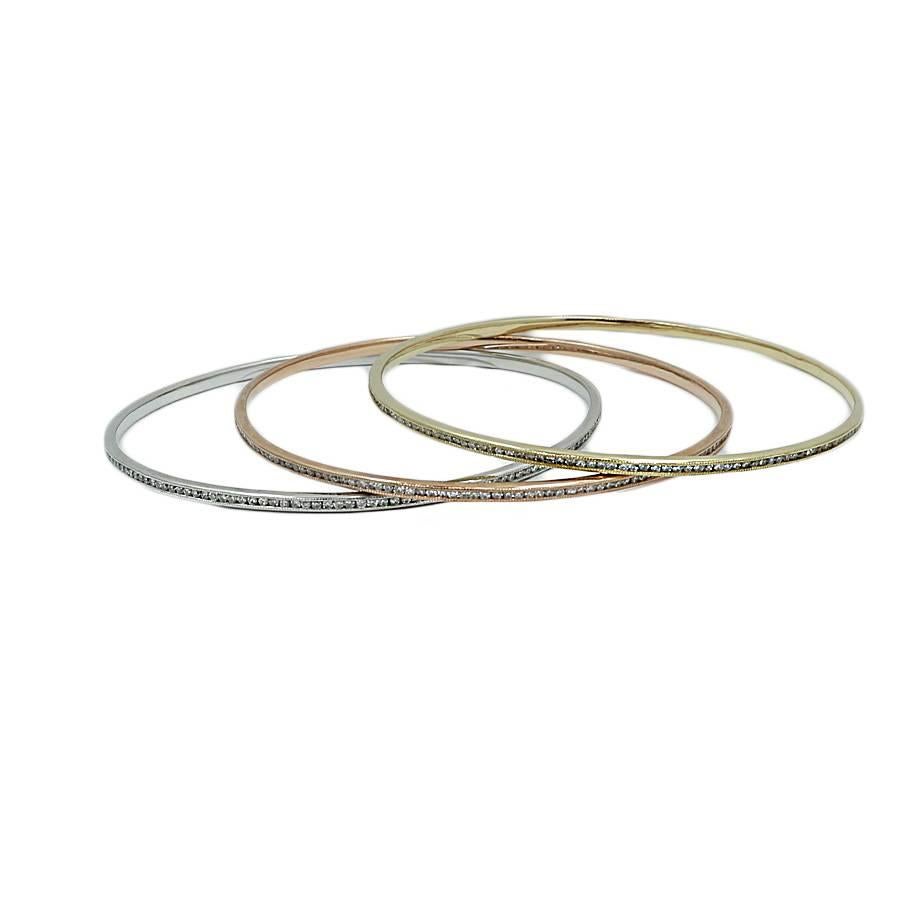 14k three tone bangle set of 3. The Bangles have round brilliant diamonds weighing a total of 5.25 carats. The bracelets measure 3.0 inches in width and weigh a total of 26.7 grams. They are in excellent condition.