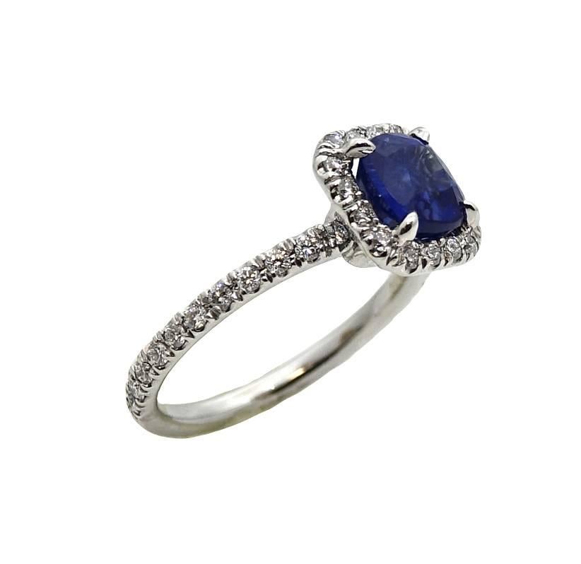 This Platinum Ring Has A Center Cushion Cut Heated Sapphire  (AGL Report #:1079603) and Diamonds Weighing A Total Carat Weight Of .50 Carats F-G in Color and VS Clarity. This Ring Is A Size 5.5.