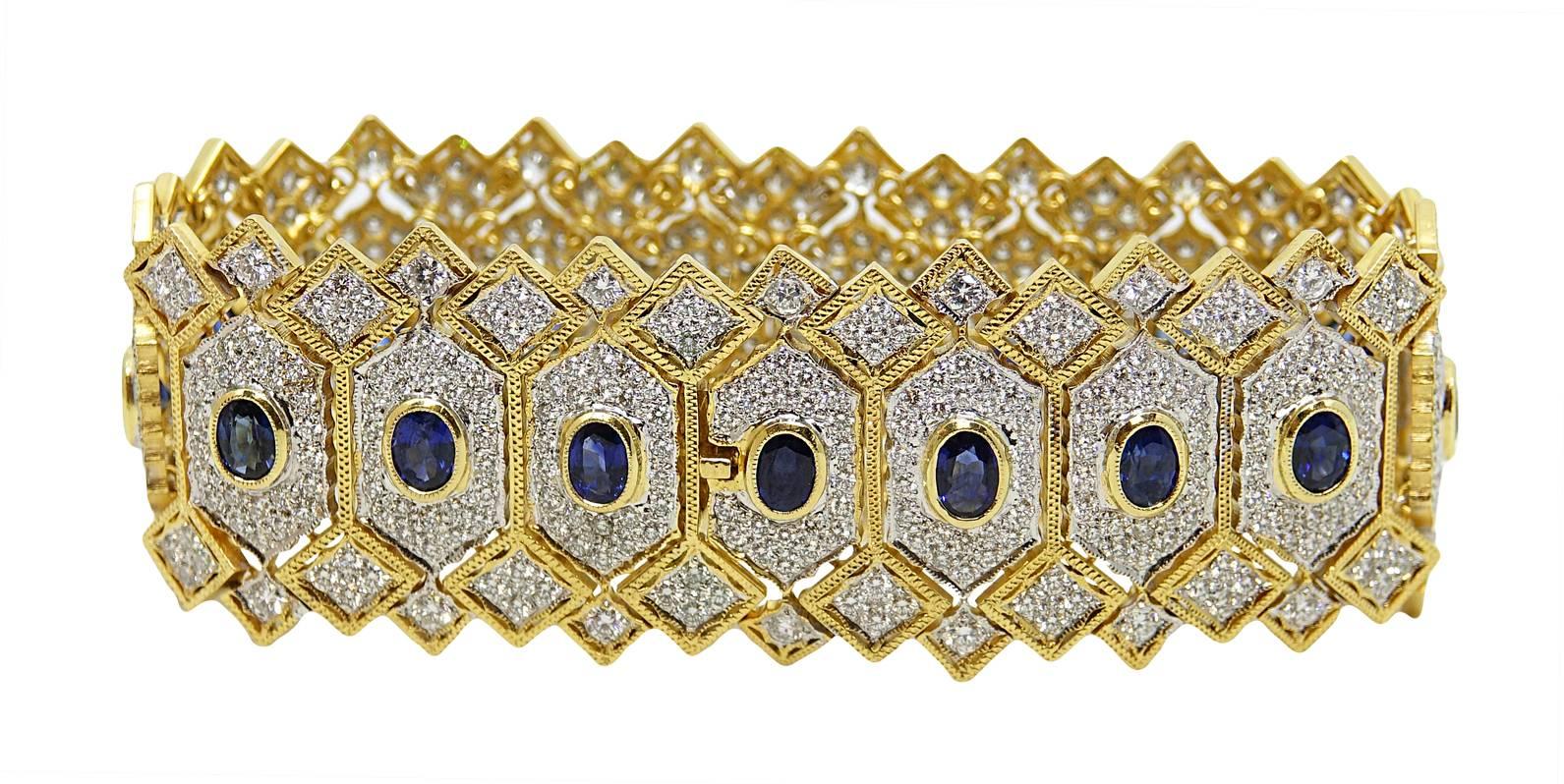This 18K Yellow Gold and White Gold Bracelet Has A Total Of 18 Blue Oval Cut Sapphires Weighing A Total Carat Weight Of 9.00 Carats, and a Total Of 576 Diamonds Weighing A Total Carat Weight Of 10.00 Carats. This Bracelet Is 7.5 Inches In Length. 