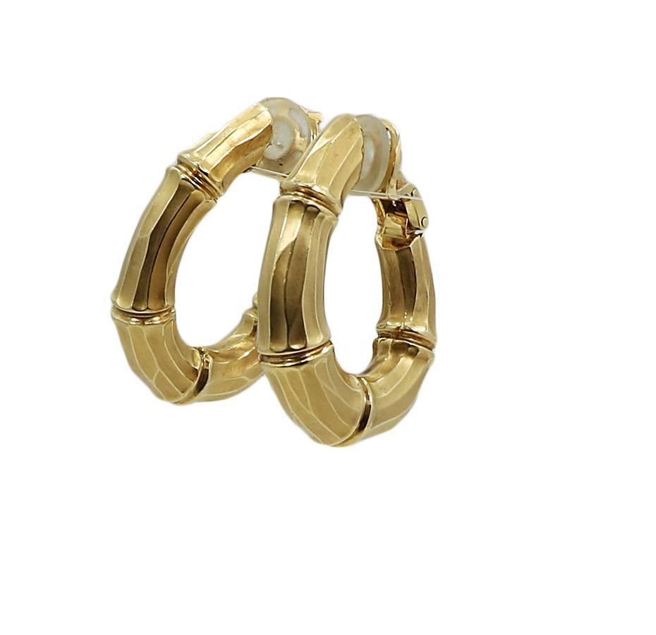 Cartier 18k yellow gold bamboo hoop earrings. They measure 1.375 inches in height and weigh a total of 27.8 grams. The earrings are in excellent condition. 