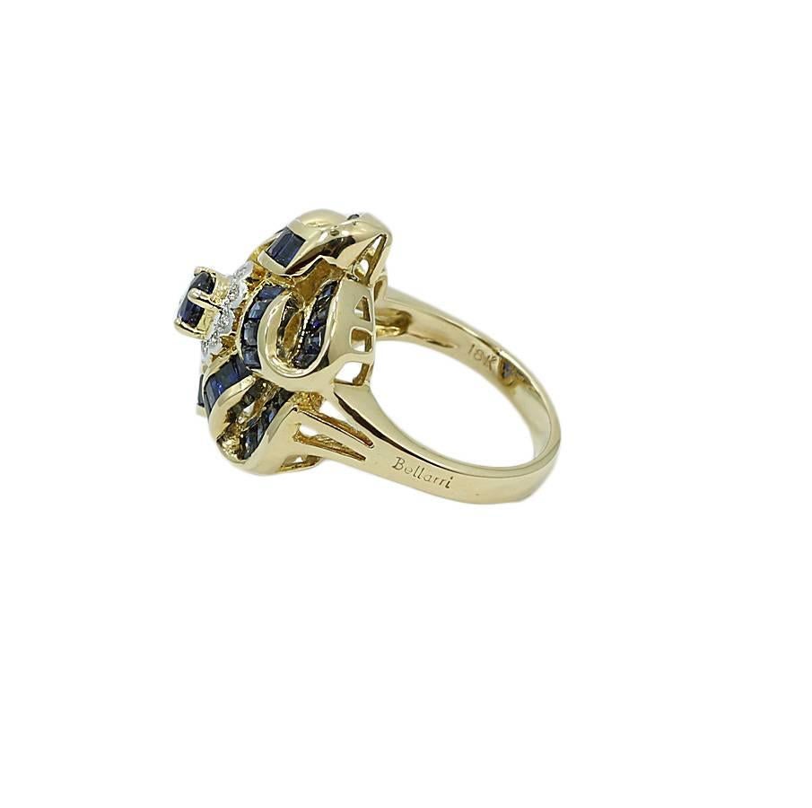 18K yellow gold diamond and sapphire flower style ring. The 49 sapphires weigh approximately 4.00 carats total weight and the 10 diamonds weigh 0.15 carats total weight. The ring sits at a size 7 and weighs a total of 11.7 grams. The ring is in