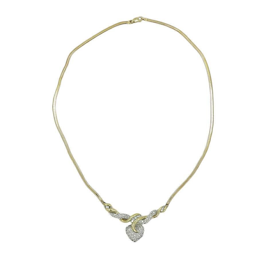 14k two tone heart necklace with baguettes and pave diamonds. The Diamonds weigh approximately 1.50 carats total weight. It measures 18 inches in length and weighs a total of 16.1 grams. The necklace is in excellent condition. 