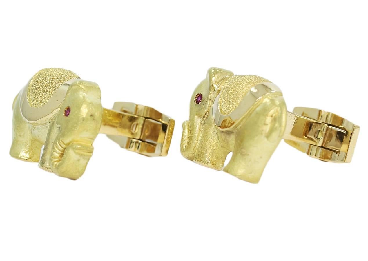 18k yellow gold elephant cufflinks measure approximately 1 inch in width. The cufflinks are in excellent condition. Each elephant has a red ruby eye. Total weight is 25 grams.