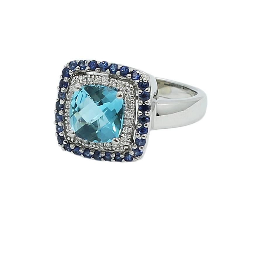 14k white gold double halo diamond sapphire and topaz ring. The diamonds weigh approximately 0.30 carats total weight and the topaz weighs approximately 2.00 carats total weight. The ring sits at a size 7.5 and weighs a total of 6.2grams. The ring