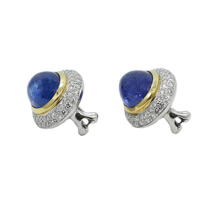18k two tone gold sapphire and diamond Cabochon button earrings. The diamonds weigh approximately 1.50 carats total weight and the 2 sapphires weigh approximately 14.17 carats total weight. They measure 0.75 inches in length and 0.5 inches in width.