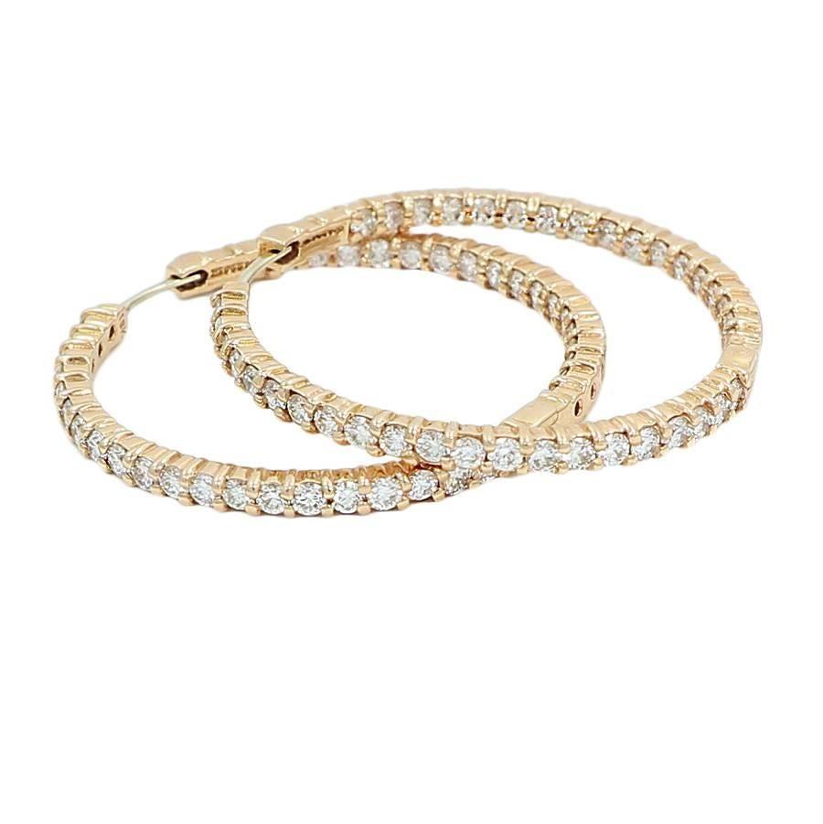 Roberto Coin 18k rose gold perfect diamond hoop earrings. The diamonds weigh approximately 3.45 carats total weight. They measure 1.5 inches in width and weigh a total of 13.8 grams. It has 2 rubies as his signature stamp. The earrings are in