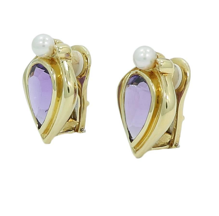 14k yellow gold amethyst and pearl earrings. They measure 1.125 inches in height by 0.825 inches in width. They weigh a total of 25 grams. The earrings are in excellent condition. 