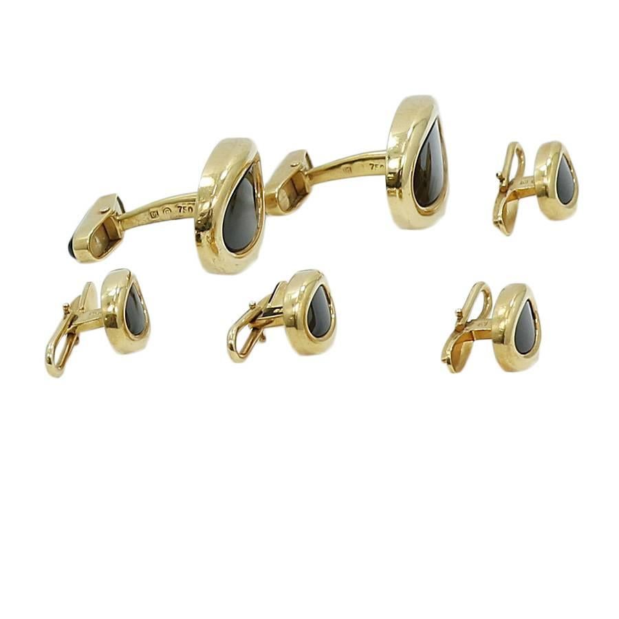 Black onyx and 18k yellow gold cufflinks and shirt stud set. The shirt studs measure 1.00 inch in length by 0.75 inches in width. The cufflinks measure .5 in length by 0.375 inches in width. They weigh a total of 43 grams. The cufflinks and shirt