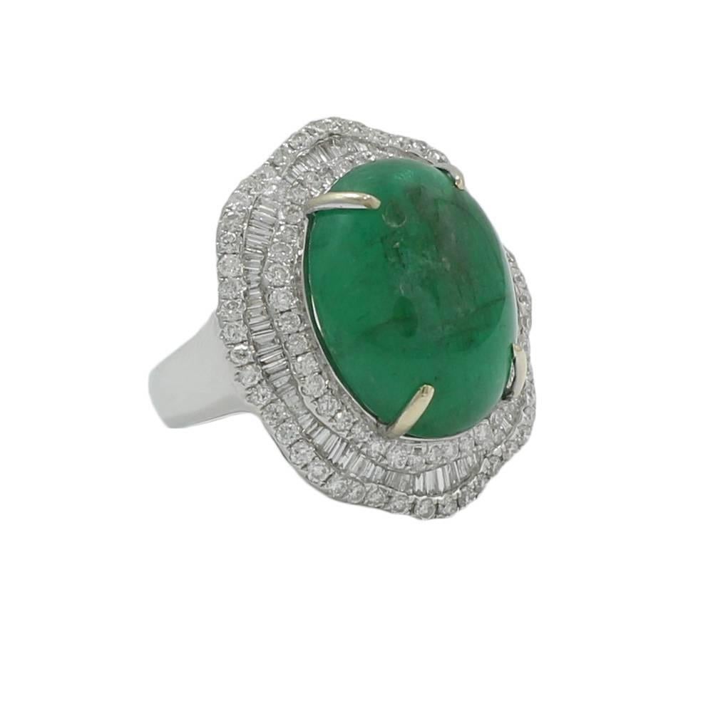  18k white gold diamond and cabochon emerald ring. The emerald weighs 17.00 carats total weight. The round and baguette diamonds weigh 1.99 carats total weight. The ring sits at a size 7 and weighs 12.0 grams. The ring is in excellent condition.