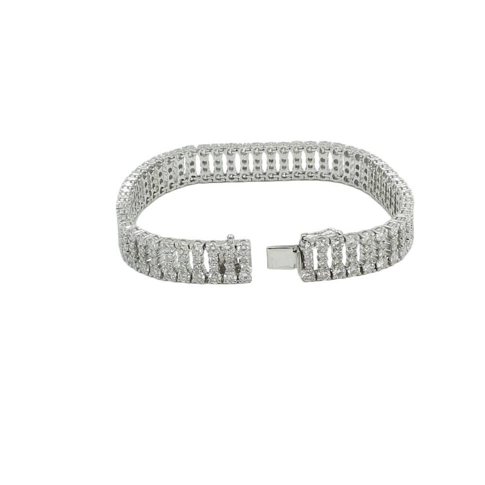 18k white gold and diamond bracelet. The diamonds F-G in color and VS in clarity. The diamonds weigh 14.75 carats total , it measures 7.00 inches in length and weighs a total of 28.6 grams. The bracelet is in excellent condition. 