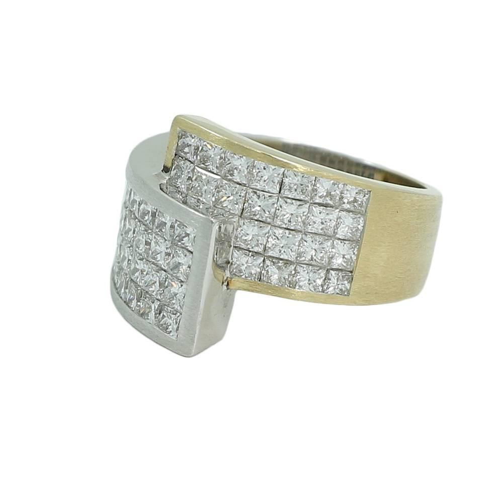 14K two tone gold invisible set diamond ring. The diamonds F-G in color and VS2-SI1 in clarity weighing 2.77 carats total weight. The ring is a size 6.75 and weighs a total of 11.6 grams. The ring is in excellent condition.