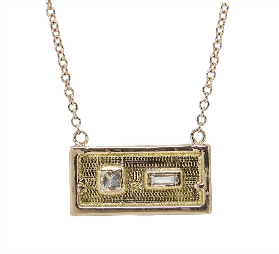 This Julez Bryant Pendant Necklace Is A Simple and Sweet Addition To Add To Any Form Of Attire. This 14K Rose Gold Necklace Has A Rectangular Pendant With A Baguette Cut Diamond Gently Set Next To A Sparkling Princess Cut Diamond Weighing A Total