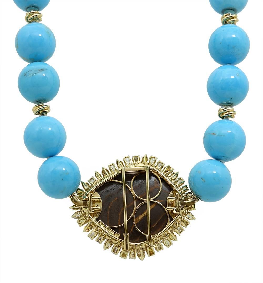 This Vibrant 18K Yellow Gold Pamela Huizenga Necklace Has Vibrant 18mm Turquoise Beads With 18K Yellow Gold Knots. A Gorgeous Boulder Opal Is The Center Piece Of This Piece and Weighs A Total Carat Weight Of Carats. Fancy Diamonds and White Diamonds