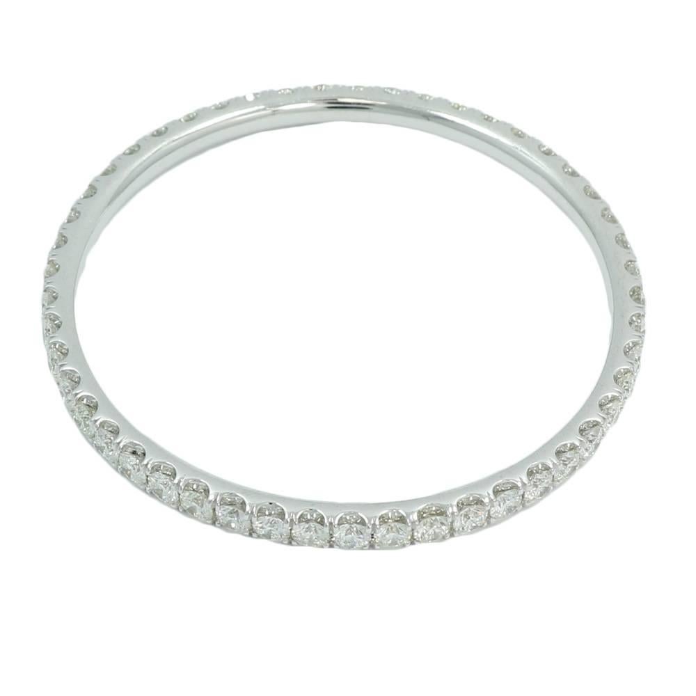 18K White Gold Eternity Bangle Bracelet with Round Brilliant Cut Diamonds. The 49 Diamonds Weigh 13.27 Carats Total Weight. It measures 2.5 Inches In Width and Weighs A Total Of 34.6 Grams 