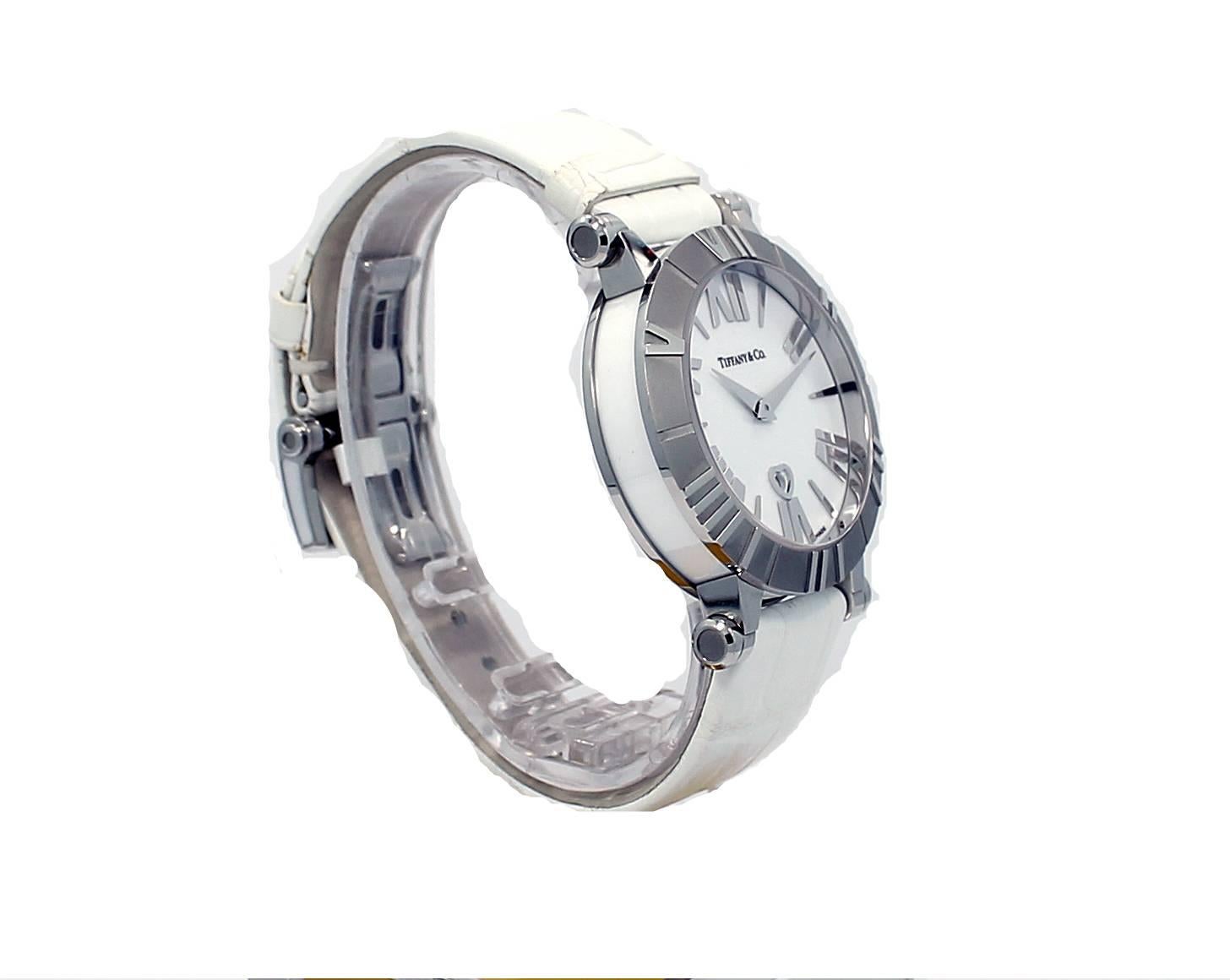 Tiffany & Co watch with 31mmm case , white dial, Roman numerals, stainless steel case, sapphire crystal, water resistant, white alligator strap with deployment buckle. The watch has a Swiss made quartz movement. Reference number #Z1301.11.11A20A71A,