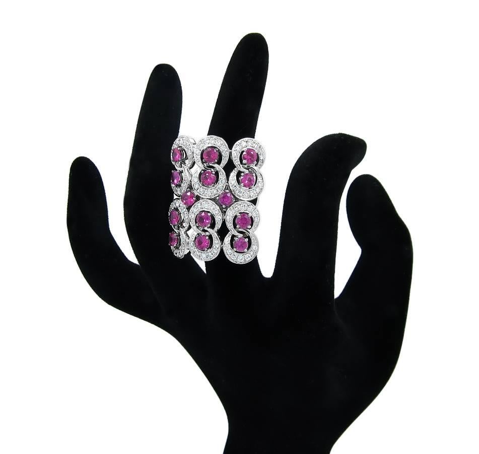 This ring is very impressive with it dark hued pink sapphires and design. There are 14 pink sapphires that average .32cts each (4.50ctw) and are all prong set with black rhodium plated 18k white gold. The round brilliant diamonds are of great