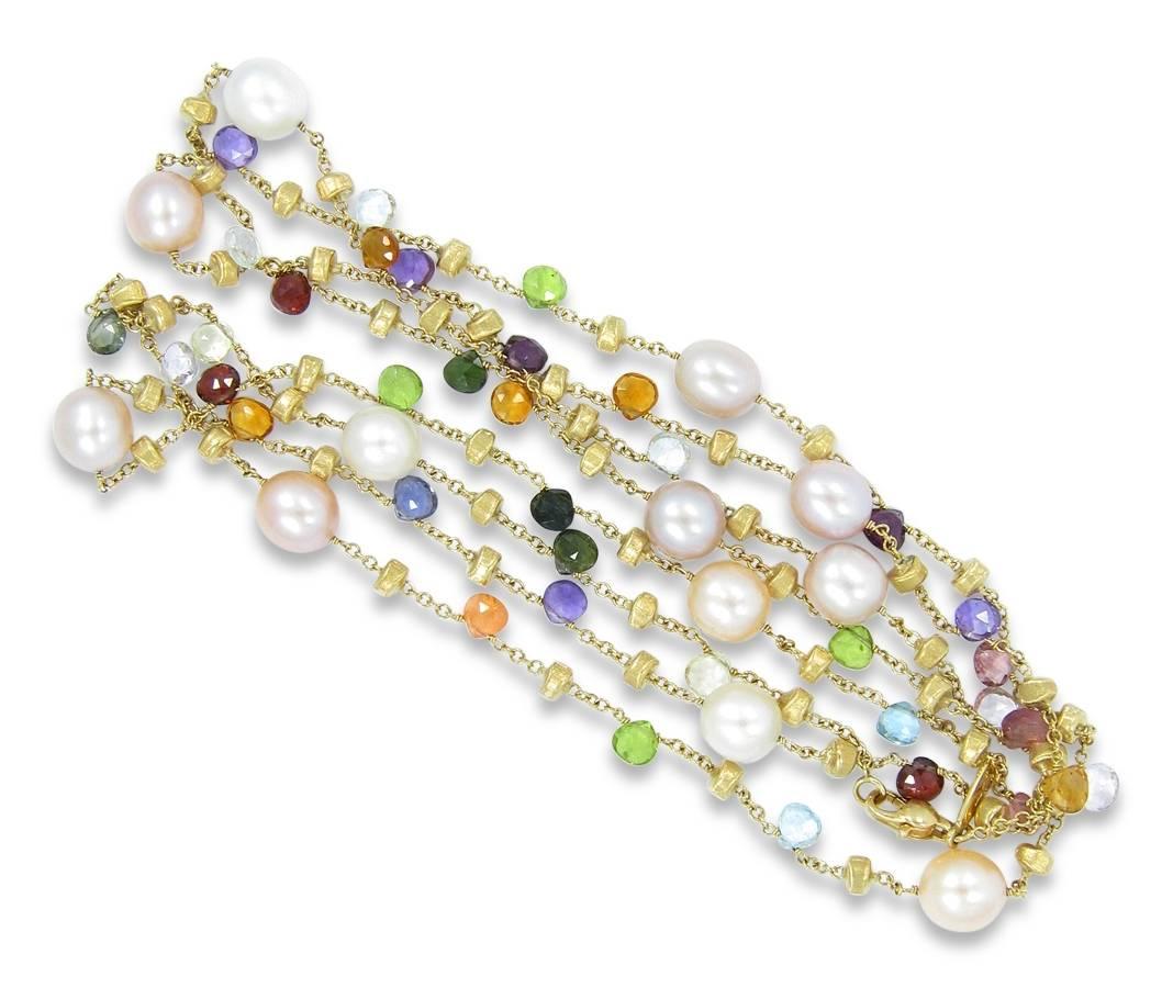 This Marco Bicego Paradise necklace holds 12 pearls and 37 faceted semi-precious stones of mixed colors. Chain is 47