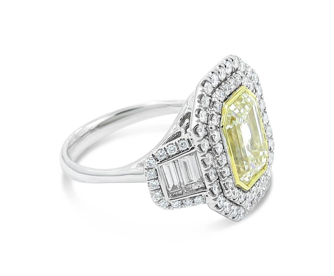 18k white gold engagement ring with double row halo 18k yellow gold bezel set emerald cut center diamond and bezel set baguette sides with pave set round diamonds. Center Fancy Yellow diamond is 4.01cts and measures 10.01 x 7.88 x 5.50mm, 4 baguette