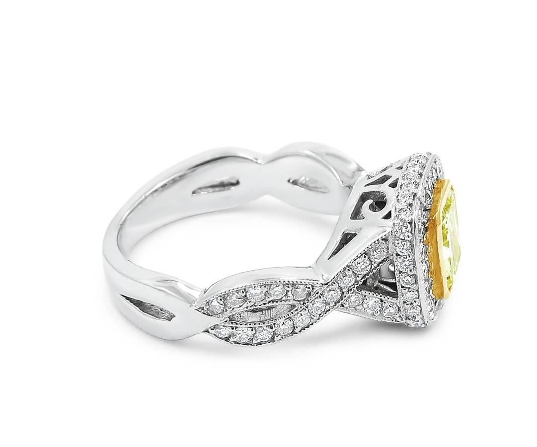 14k two tone ladies engagement ring with full bezel set fancy radiant cut diamond ( 1.03cts ) and pave set round diamonds (.72ctw). Diamonds are F-G in color and SI in clarity. Ring sits at a size 6.