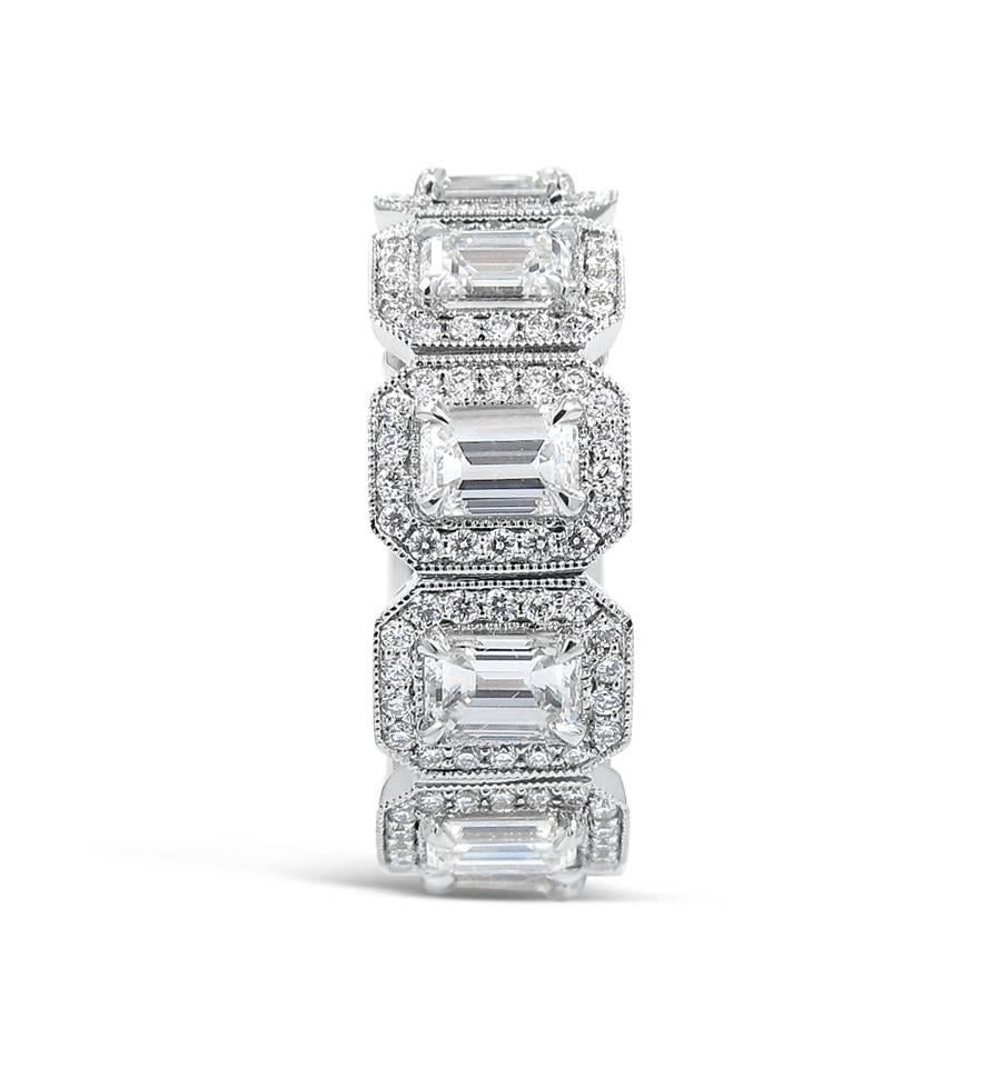 18k white gold ladies eternity band with four prong set emerald cut diamond centers and cut corner halo style 2 bead pave set round diamonds. There are 10 emerald cut diamonds which equal 3.55ctw and 180 round diamonds which equal 1.01ctw. Ring is