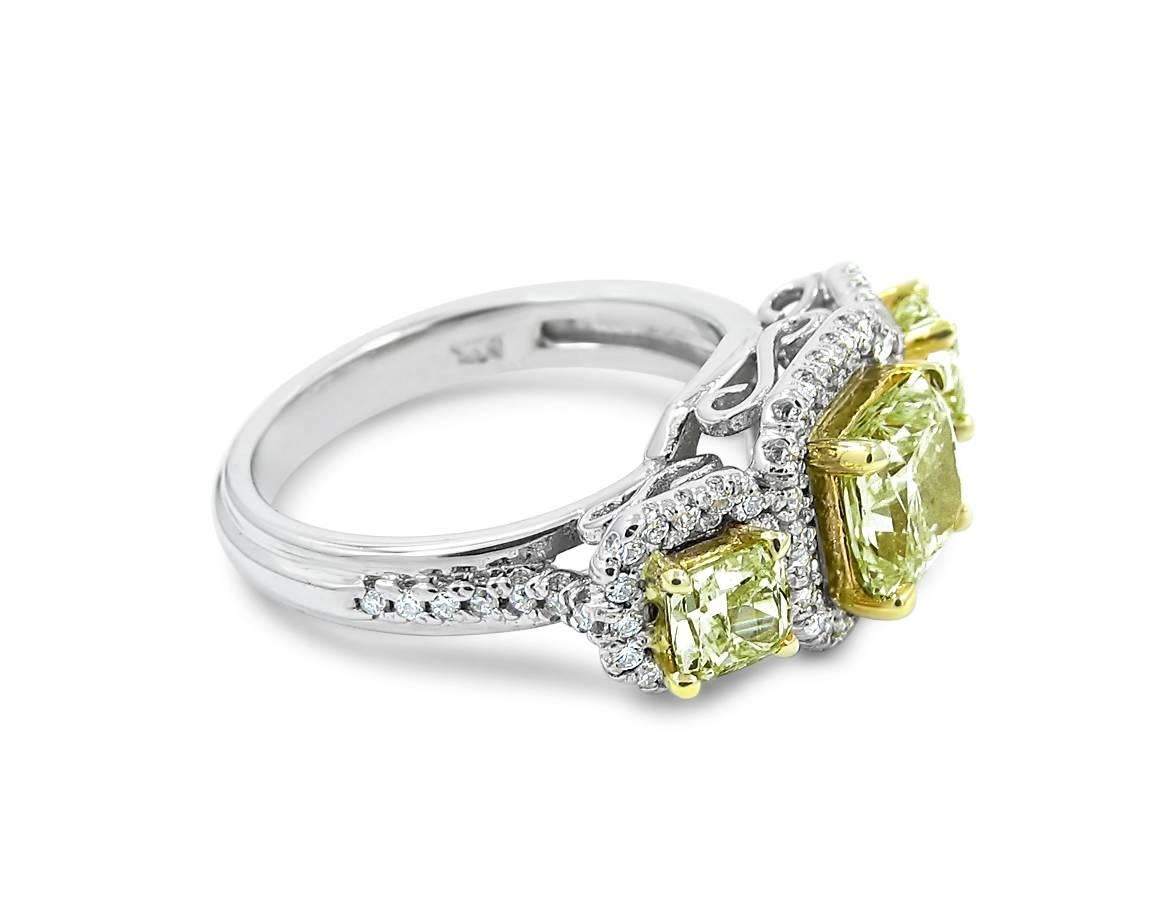 14K Two Tone ladies three stone ring with Radiant cut Fancy Yellow Center Diamonds and Prong set round diamonds. Center Fancy Yellow Diamond weighs 1.30cts and each side Fancy Yellow diamond weighs .39cts. There are .37cts of round brilliant