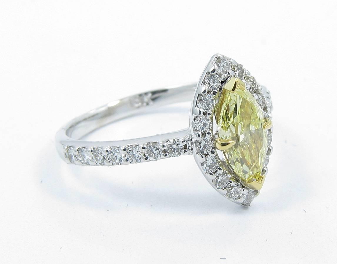 18k white gold 1.04ct fancy yellow marquise center diamond with .65ctw of round brilliant diamond halo all prong set. 
GIA 1149454913
Ring sits at a size 7 and can be sized.