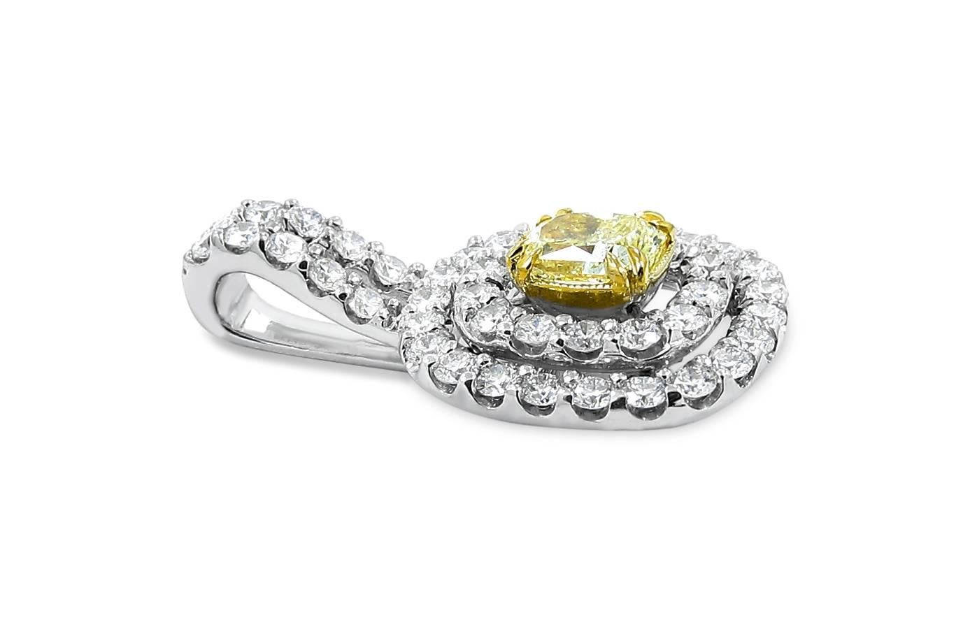 14k white gold and yellow gold basket pendant with fancy light yellow center radiant diamond and double halo round diamond sides with split bale. Center diamond weighs .84cts and side diamonds total 1.18ctw. Pendant measures 1 inch from top of bale