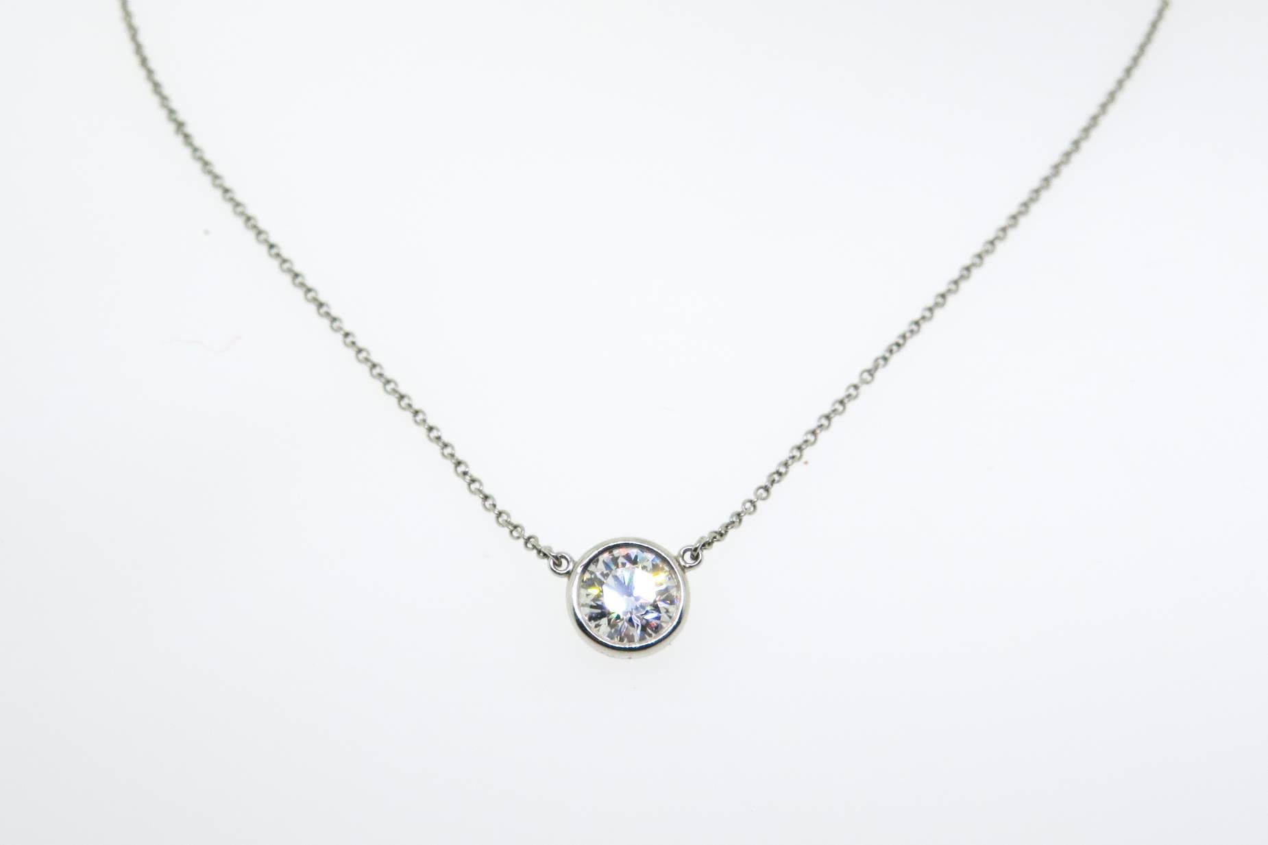 Tiffany Single round diamond catches the light and makes it dance. This Pendant is crafted in Platinum with a 0.90 carat round brilliant diamond G/H color, SI1 clarity, on a 16