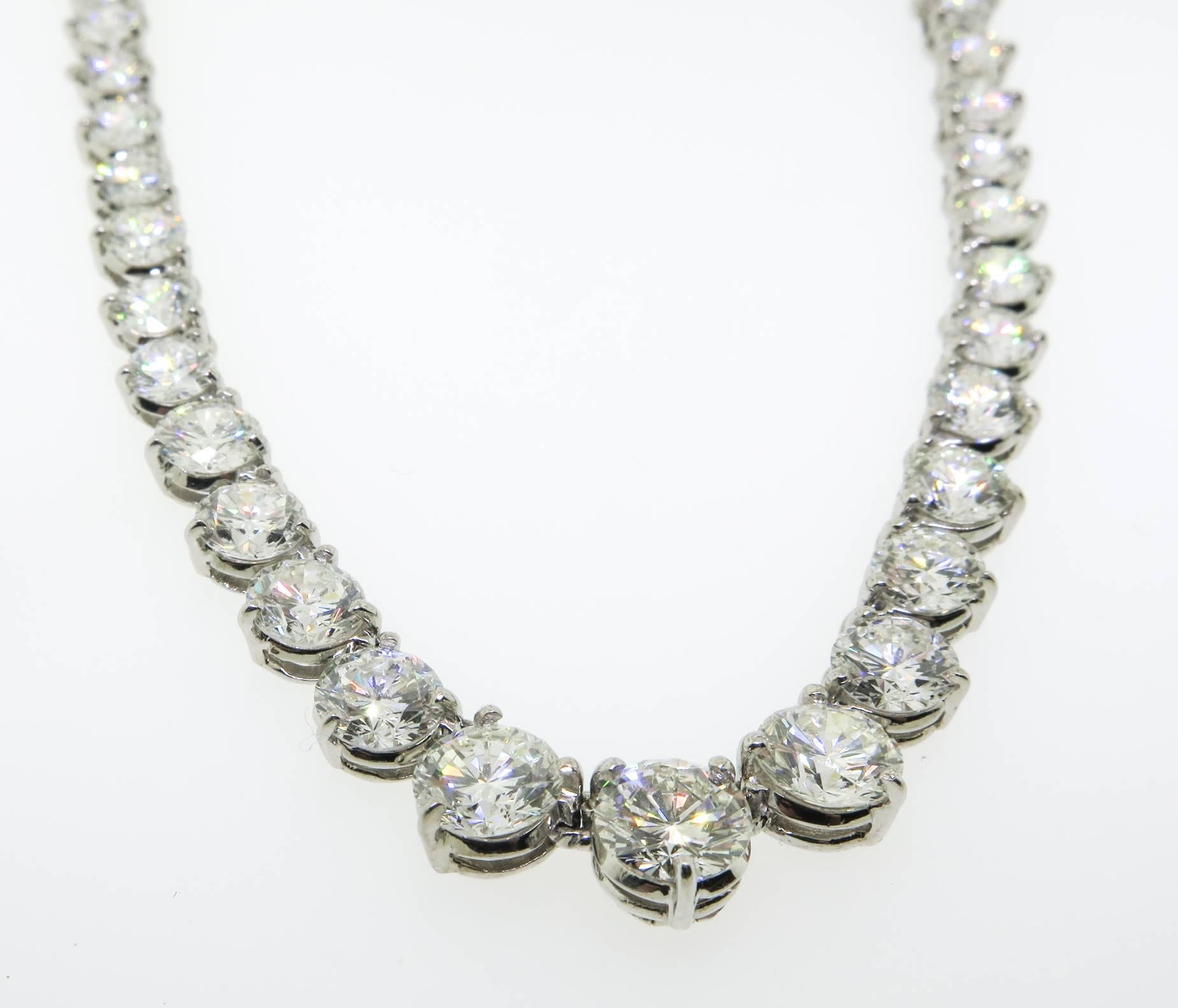 This stunning Riviera necklace features 71 round brilliant cut diamonds with a total carat weight of 24.90 carats. The diamonds are F-G in color and VS1-VS2 in clarity. The diamonds are prong set individually and the diamonds graduate in size. The